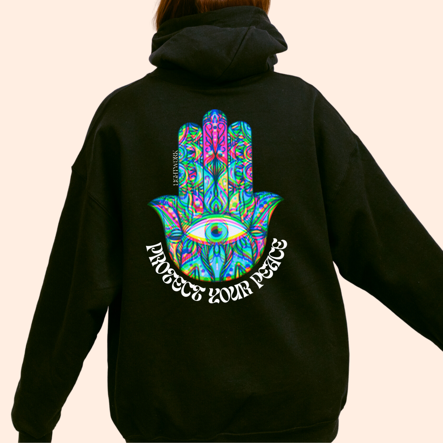 black spiritual hoodie. Psychedelic hamsa graphic with "protect your peace" text.